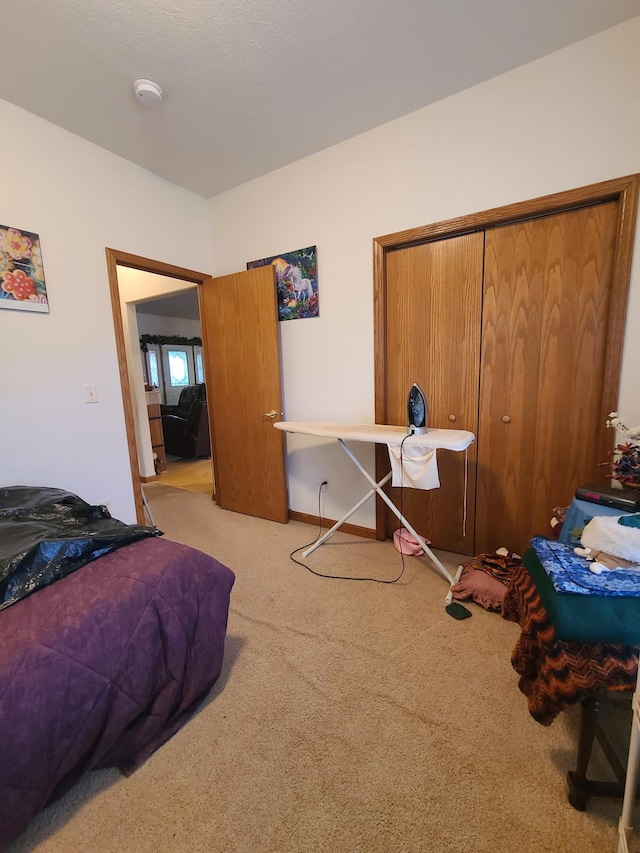 carpeted bedroom featuring a closet