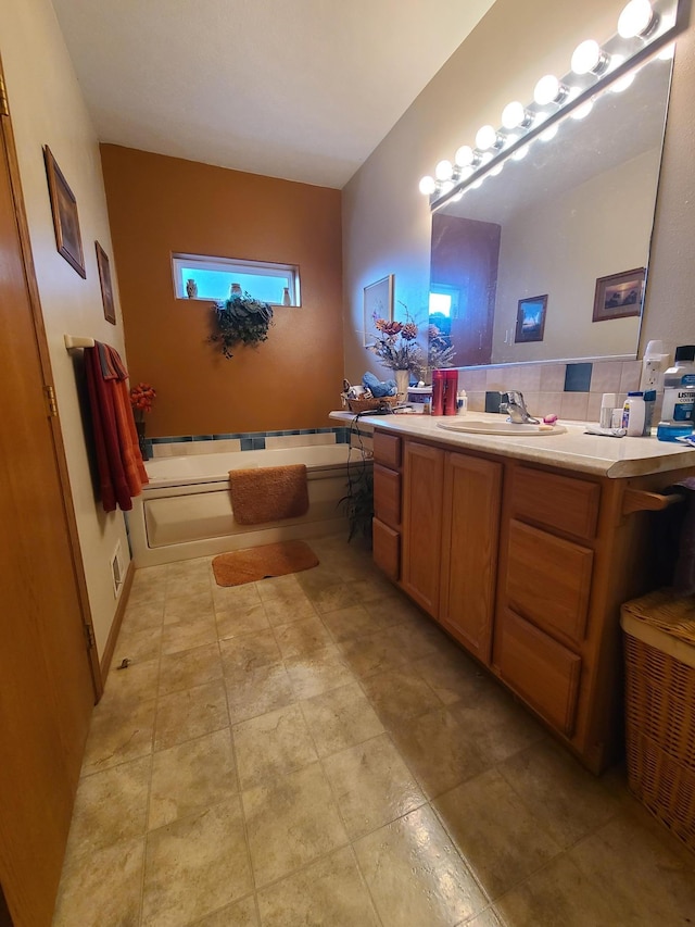 bathroom featuring tasteful backsplash, vanity, and a washtub