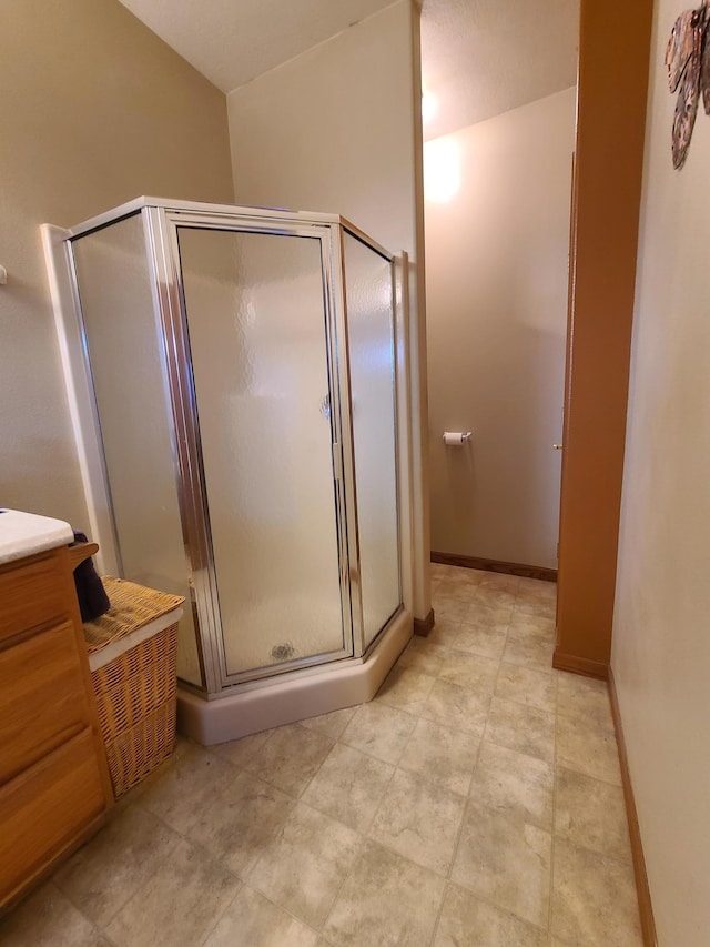 bathroom featuring an enclosed shower and vanity