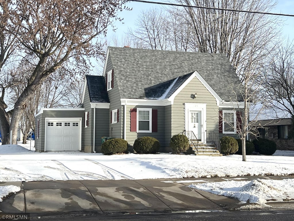 cape cod house featuring a garage