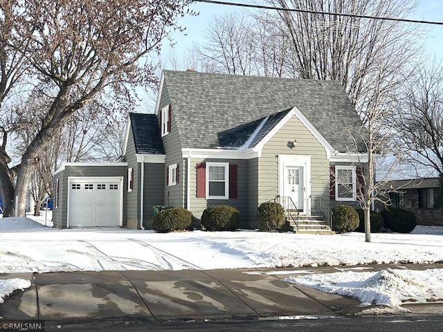 cape cod house featuring a garage