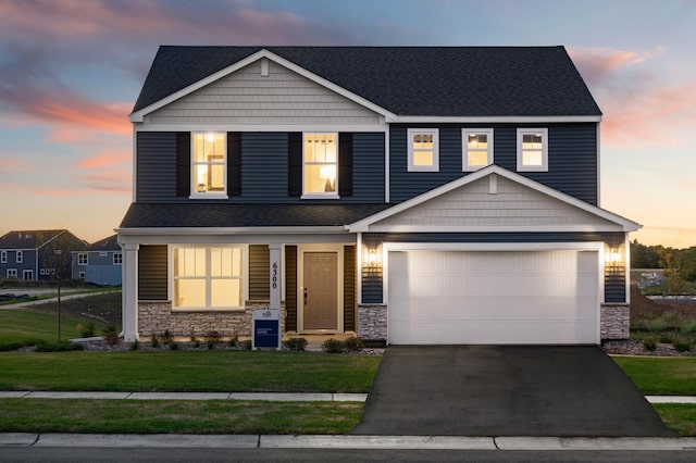 craftsman house with a garage and a lawn