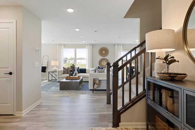 stairway with hardwood / wood-style floors