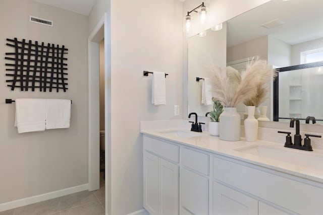 full bathroom with tile patterned flooring, visible vents, a sink, and double vanity