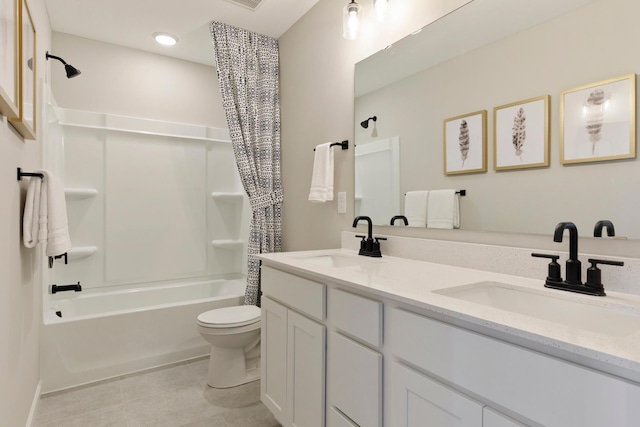 full bath featuring shower / bath combo with shower curtain, tile patterned flooring, a sink, and toilet