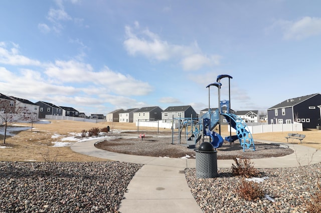 community playground featuring a residential view and fence