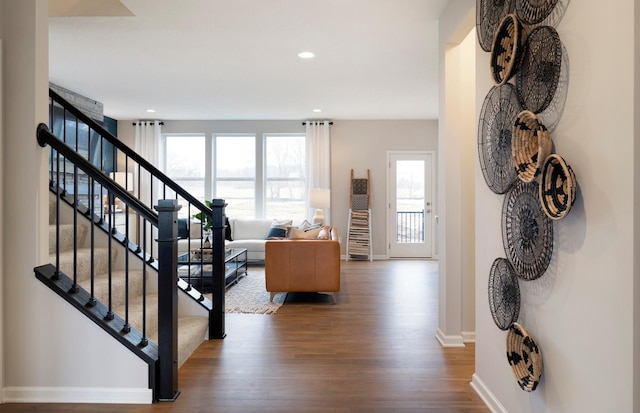 staircase featuring a wealth of natural light and hardwood / wood-style floors