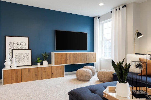 carpeted living area with recessed lighting