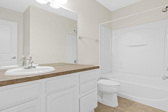 bathroom with tub / shower combination, vanity, toilet, and tile patterned floors