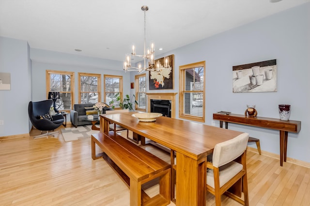 dining area featuring a notable chandelier and light wood-type flooring