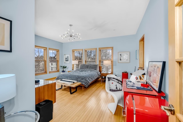 bedroom featuring light hardwood / wood-style floors and a notable chandelier