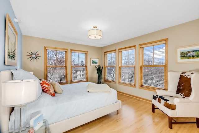 bedroom featuring hardwood / wood-style floors and multiple windows