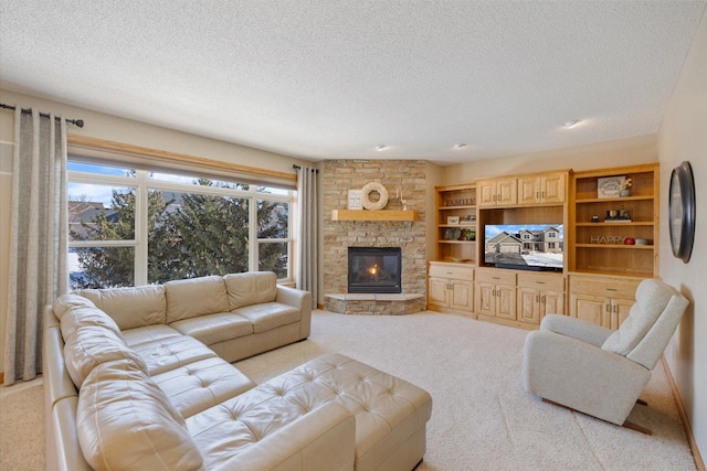 living room with light carpet, a fireplace, and a textured ceiling