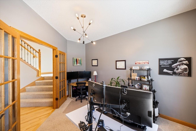 home office with an inviting chandelier, baseboards, and wood finished floors