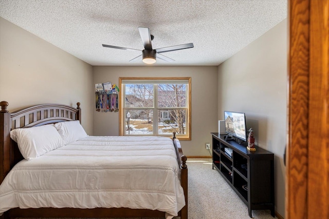 bedroom with a ceiling fan, carpet, a textured ceiling, and baseboards