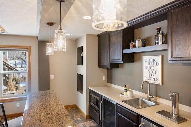 kitchen with light countertops, wine cooler, a sink, and dark brown cabinetry