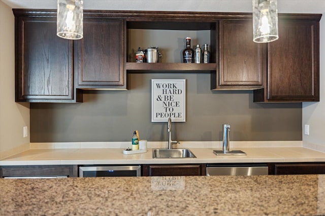 kitchen with a sink, dark brown cabinets, light countertops, dishwasher, and open shelves