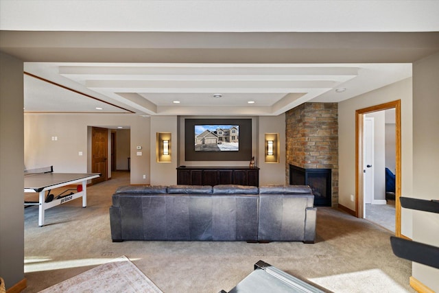 living area with a tray ceiling, a fireplace, recessed lighting, carpet flooring, and baseboards