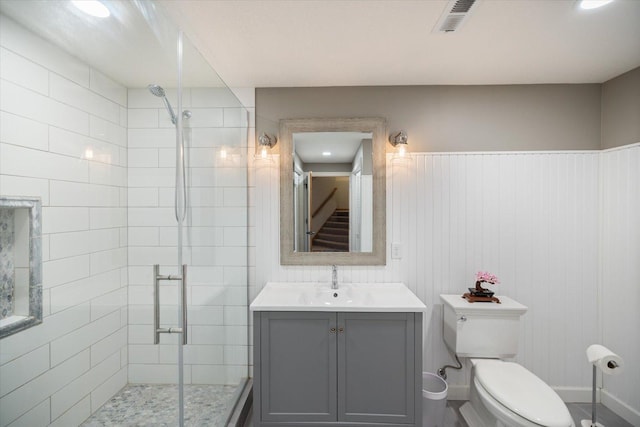 bathroom featuring visible vents, vanity, a shower stall, and toilet