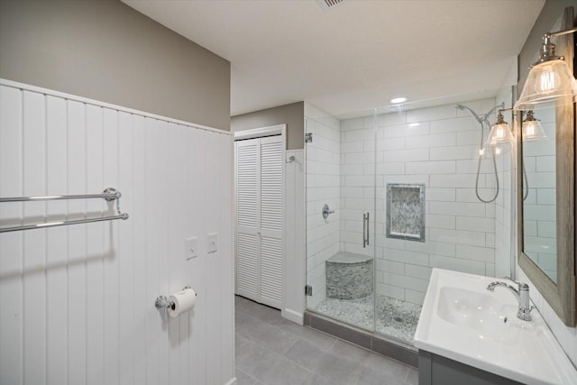 bathroom featuring a stall shower, tile patterned flooring, and vanity