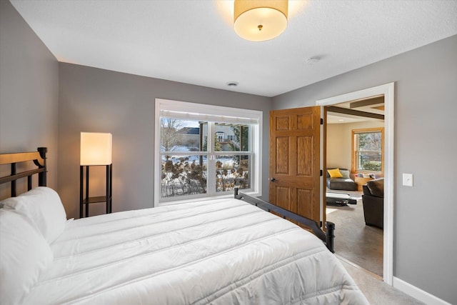 bedroom featuring carpet floors and baseboards