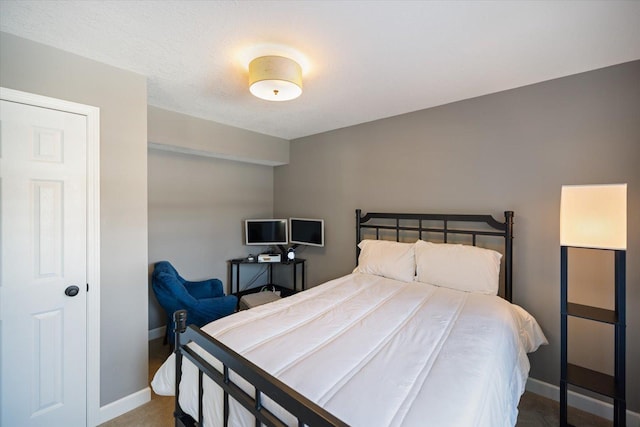 bedroom featuring baseboards and carpet flooring