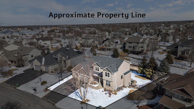 snowy aerial view with a residential view