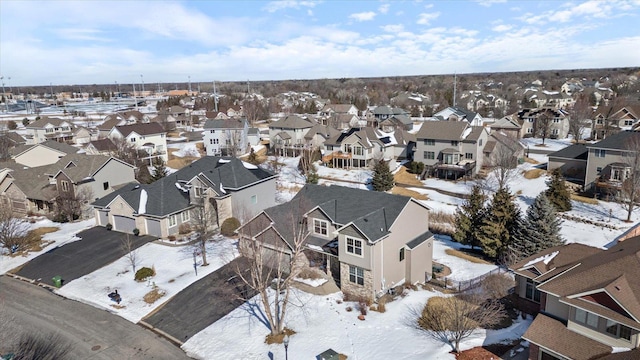 snowy aerial view featuring a residential view