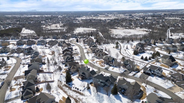 snowy aerial view with a residential view