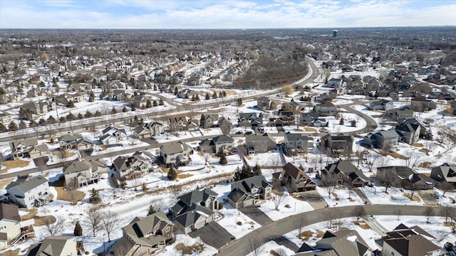 snowy aerial view with a residential view