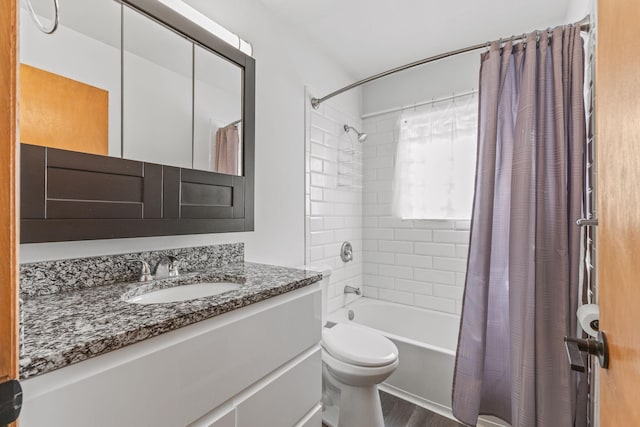 full bathroom with hardwood / wood-style flooring, toilet, vanity, and shower / bath combo