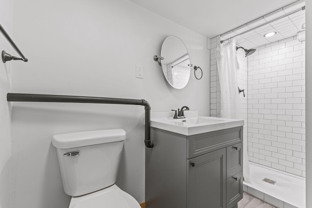 bathroom with toilet, vanity, and a shower with shower curtain