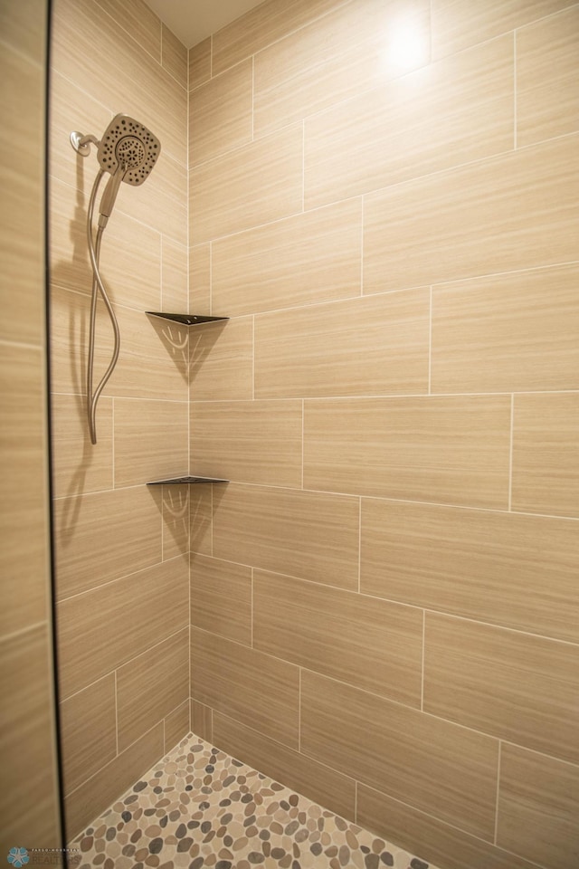 bathroom with a tile shower