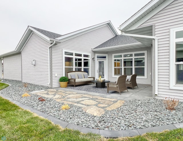 rear view of property with an outdoor hangout area, a shingled roof, and a patio area