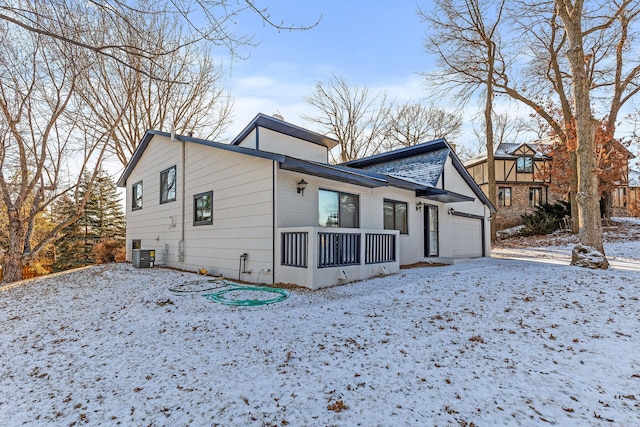 view of front of home featuring cooling unit and a garage