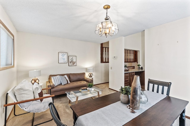 dining room featuring an inviting chandelier and light colored carpet