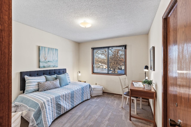 carpeted bedroom featuring a textured ceiling