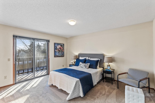 bedroom featuring carpet floors, access to outside, and a textured ceiling