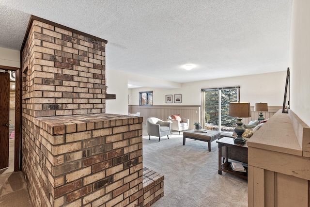 carpeted living room featuring a textured ceiling