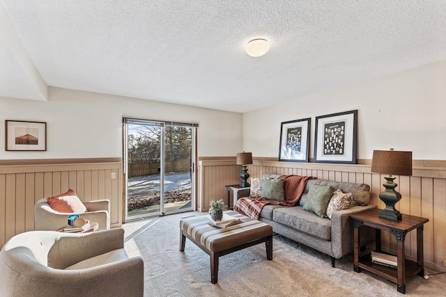 living room featuring light carpet and a textured ceiling