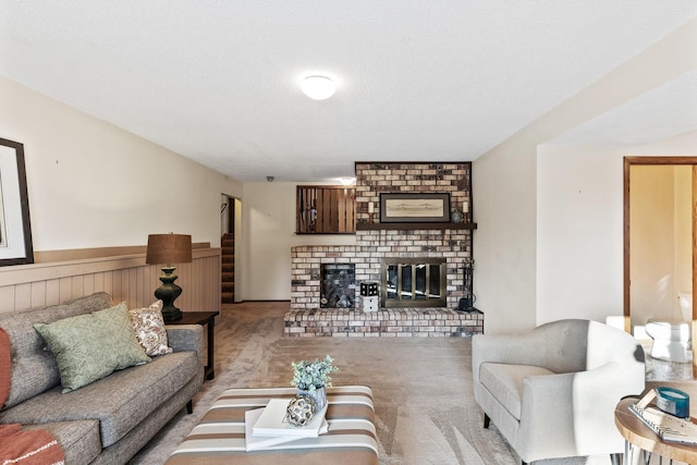 carpeted living room with a brick fireplace and a textured ceiling