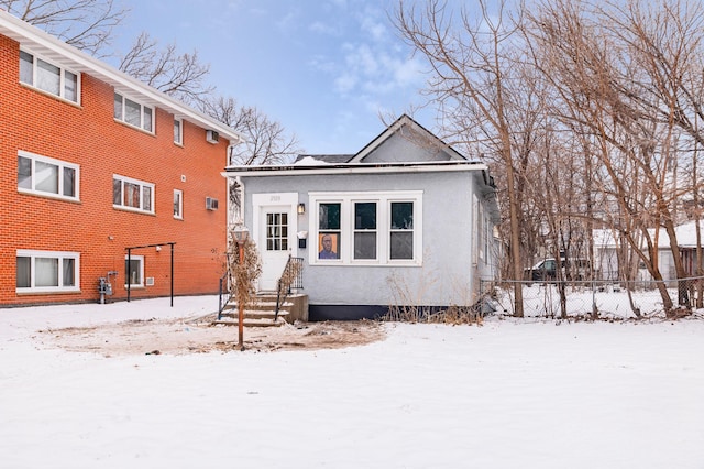 view of front of property featuring fence and stucco siding