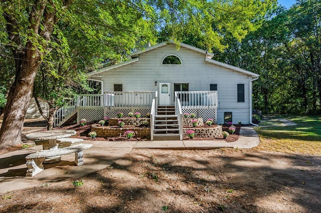 view of front facade with a wooden deck