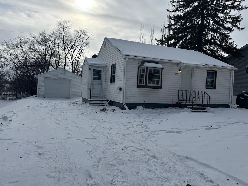 view of front facade with a garage and an outbuilding