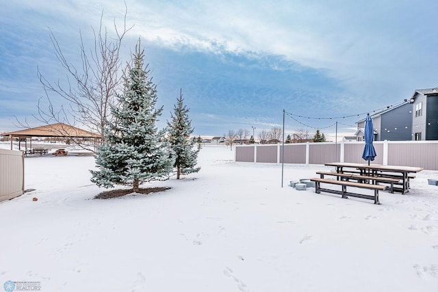 yard covered in snow with a gazebo