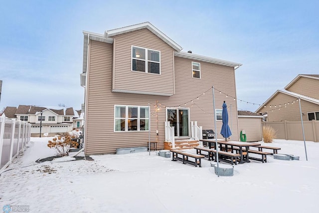 view of snow covered rear of property