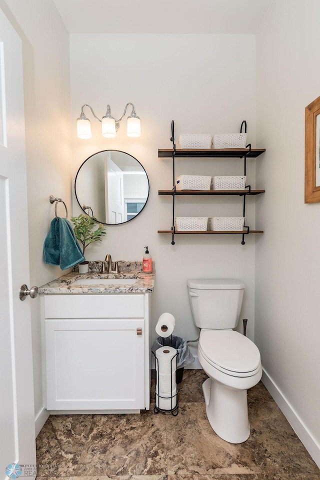 bathroom with toilet and vanity