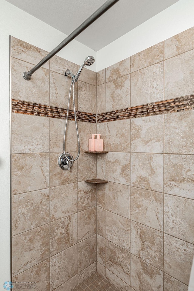 bathroom with a tile shower