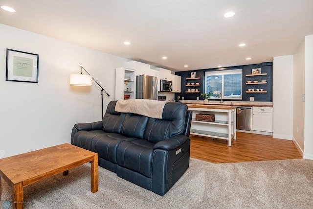 carpeted living room featuring sink