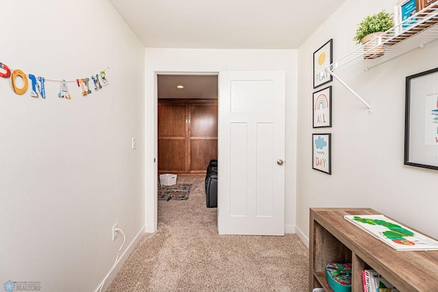 hall featuring light carpet